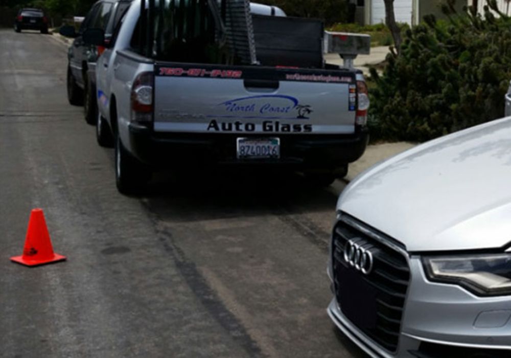 North Coast Auto Glass truck parked beside a customer car during a mobile job
